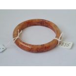 An unusual red jade bangle