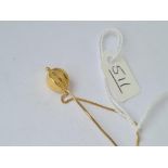 A jabot style gold stick pin with balloon terminal in high carat gold