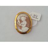 A cameo of a girl and bird in 9ct