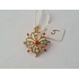 An attractive opal starburst brooch/pendant with central small ruby set in gol120d- 5.1gms
