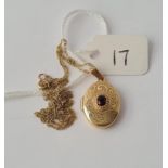 A garnet set locket on 9ct chain