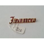 A RUBY SET NAME BROOCH 'FRANCES' IN 18CT GOLD - 4.7gms