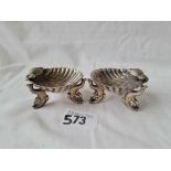 A pair of shell shaped salts standing on dolphin shaped supports 2 1/4 inches wide B'ham 1892 56 gms