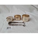 Three various napkin rings and a small pair of tongs 82 gms