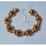 AN ATTRACTIVE GOLD PANEL BRACELET WITH 8 AMETHYST STONES IN 9CT - 8" long - total weight 32gms
