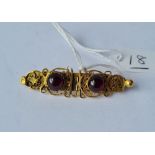 A high carat gold brooch with cabochon garnets - 4.6gms