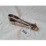 A pair of George III cast sugar tongs by GB circa 1780 and another pair London 1837 76 gms