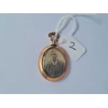 An antique double sided 9ct glass locket