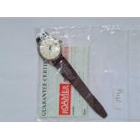 A gents Roamer quartz wrist watch with second sweep and calendar dial and papers