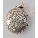 A antique Victorian hallmarked locket with scrolled decoration to front