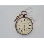 A gents large silver pocket watch and key by J Wilkinson of Bingley with seconds dial