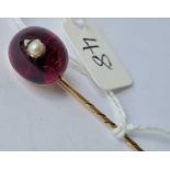 A Victorian cabochon garnet and pearl stick pin 15ct gold tested