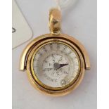 A RARE GOLD SPINNING FOB ONE SIDE IS A COMBINED COMPASS AND THERMOMETER THE REVERSE SIDE SET WITH