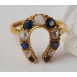 A blue and white stone horse shoe ring 18ct gold size P - 4.2 gms