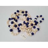 A long pearl and lapis bead necklace