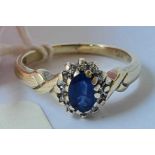 A sapphire and diamond cluster ring in 9ct white gold size N - 3.4 gms