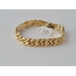 A GOLD ARTICULATED BRACERLET IN 14CT GOLD - 19.2 GMS