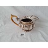 A 19th century continental milk jug with ribbed body 7 inches over handle - 325 gms