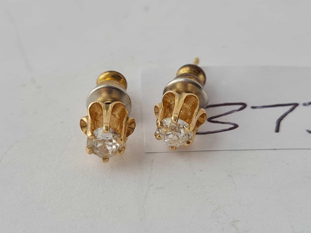 A pair of raised diamond earrings set in gold