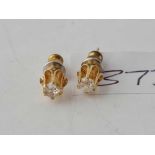 A pair of raised diamond earrings set in gold