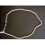 A NATURAL PEARL NECK LACE WITH PLATINUM BARREL CLASP