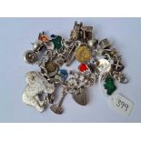 A heavy silver charm bracelet with numerous charms including large sheep dog 99g