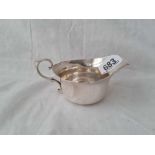 A cream jug with leaf capped handle 4.5” wide, London 1913 by W & Co. w.93g