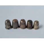 Five silver thimbles