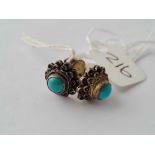 a pair of silver and turquoise filagree bulls eye style earrings