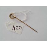 A pearl crescent topped stick pin in 9ct