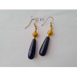 A pair of large lapis lazuli ear pendants mounted in fancy gold mounts