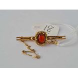 A small 9ct bar brooch set with an earlier Georgian gold mounted Cornelian