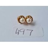 A pair of ear studs set in gold