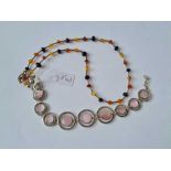 A silver and mother of pearl bracelet together with a multi bead necklace