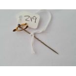 A 9ct and sapphire wishbone toped stick pin