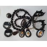 A mixed bag of Whitby jet/Vulcanite pendants, necklace brooches etc