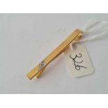 A plain 9ct tie clip set with two diamonds 3.1g