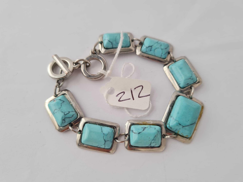 A turquoise matrix seven panel bracelet set in white metal