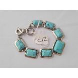 A turquoise matrix seven panel bracelet set in white metal