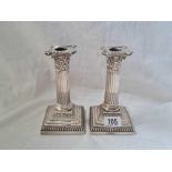 A pair of candle sticks with Corinthian capital, square bases & detachable nozzles, 6” high,