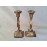 A pair of candle sticks with bulbous stems, 7” high, B'ham 1923