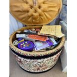 An oval tapestry work box with cotton reels etc