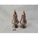A pair of late Victorian embossed baluster shaped castors - 4" high - London 1894/9 - 111 g.