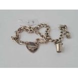 A white metal link bracelet with silver bucket charm inc a white metal bracelet with heart shaped