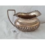 An oval half fluted milk jug with gadrooned rim - 5.5" wide - Chester 1906 - 162 g.