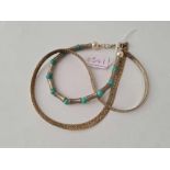 A silver necklace and silver turquoise bracelet