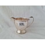 A circular cream jug on spreading rim foot - 5" wide - Birmingham 1940 - 99 g.