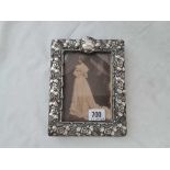 An Art Nouveau decorated photo frame with flowers and scrolls - 7.5" high - Birmingham 1902 by D&F