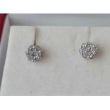A PAIR OF BOXED PRETTY DIAMOND CLUSTER EARRINGS SET IN HIGH CARAT WHITE GOLD