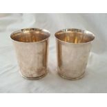 A good pair of Britannia plain beakers, 4.5" high, London 1957, from Tessiers.